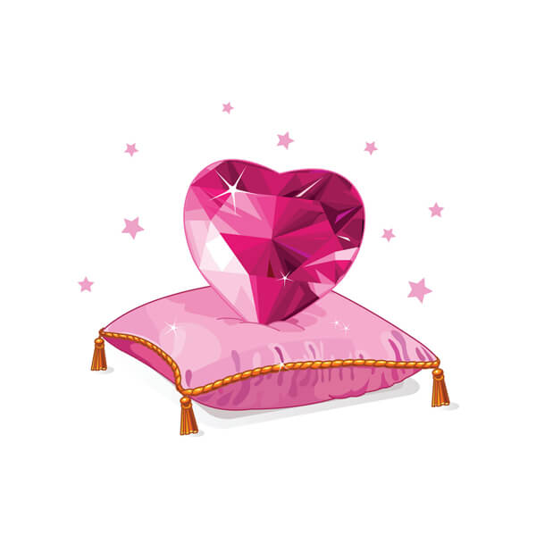 A red ruby shaped in a heart on top of a presentation pillow
